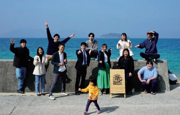 海辺で集合写真を撮る人々