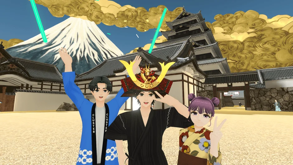 バーチャル空間で、日本の伝統的な風景を背景に3人のアニメ調キャラクターがポーズを取っています。富士山と天守閣を背に、一人は兜を被り、もう一人は法被を着ています。