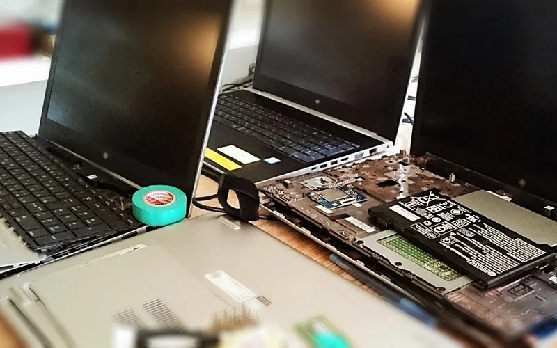 複数のノートパソコンが分解され内部部品が見えている