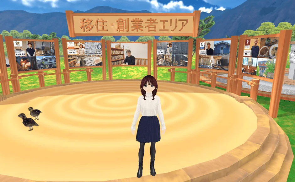 バーチャル空間のイベント会場で、アニメキャラクターが中央に立っています。「移住・創業者エリア」の看板と、移住や起業に関する情報が表示された複数のスクリーンが見えます。