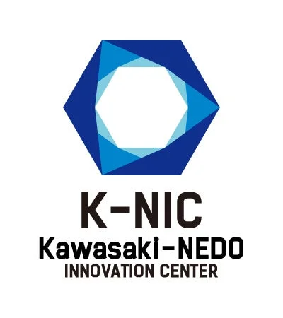 「K-NIC Kawasaki-NEDO INNOVATION CENTER」のロゴマークです。青色を基調とした幾何学的な六角形のデザインと、その下部に組織名が記載されています。