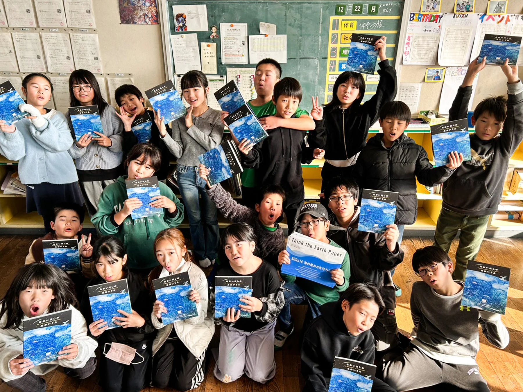 教室で環境教育関連の書籍を持つ子どもたち