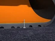 巨大なオレンジ色の機械の下部をクローズアップした画像。