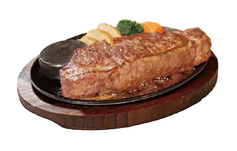 熱々の鉄板に盛り付けられた厚切りのステーキ