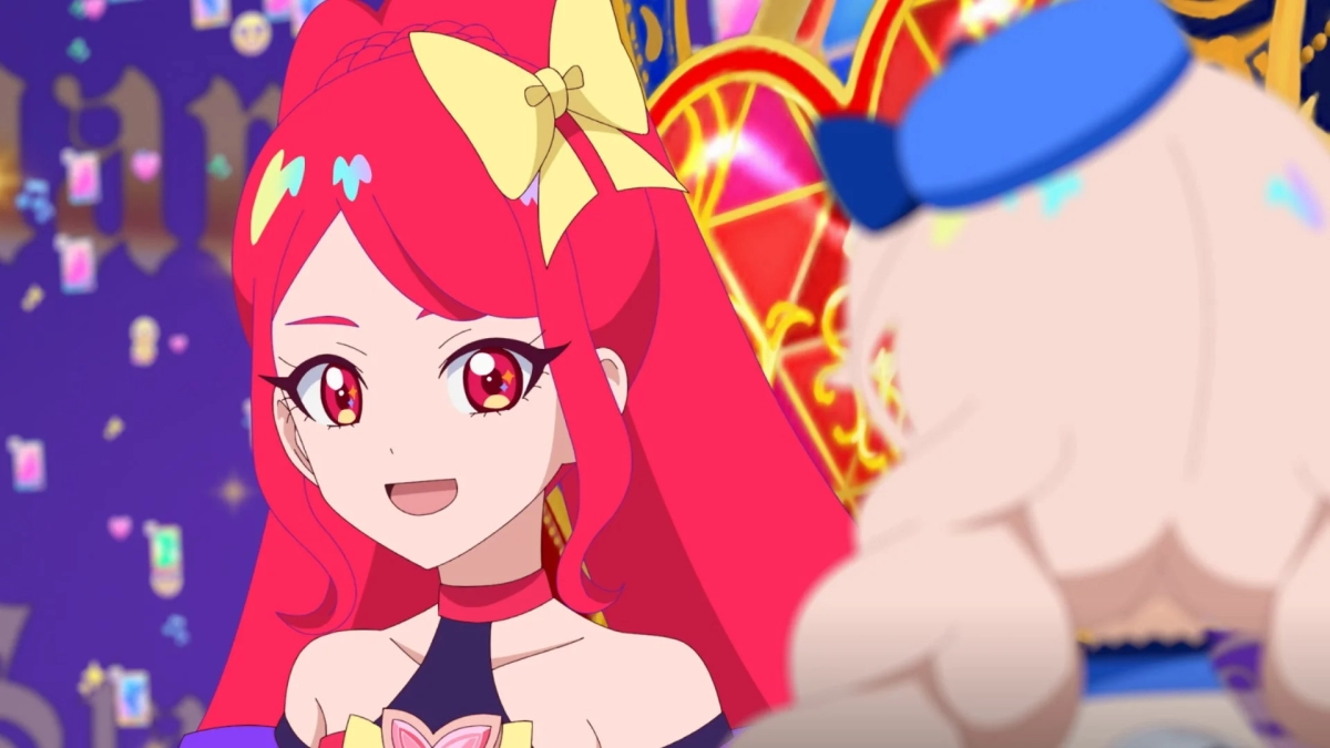 赤髪で大きな赤い瞳を持つアニメの少女が笑顔で写っています。